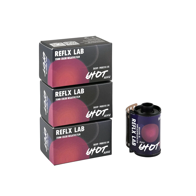 Three stacked boxes of REFLX LAB 640T 35mm film next to one loaded cartridge