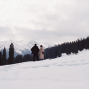 REFLX LAB 640T daylight sample photo with 80A filter: couple walking through a snowy mountain landscape