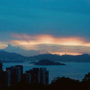 REFLX LAB 640T sample photo: twilight coastal skyline with warm clouds over water and hills