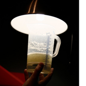 Mixing ADOX Scala reversal chemistry in graduated measuring jug showing darkroom film processing workflow