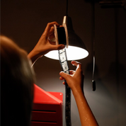 Examining developed B&W slide film strip held up to lamp light showing ADOX Scala reversal processed positive transparencies