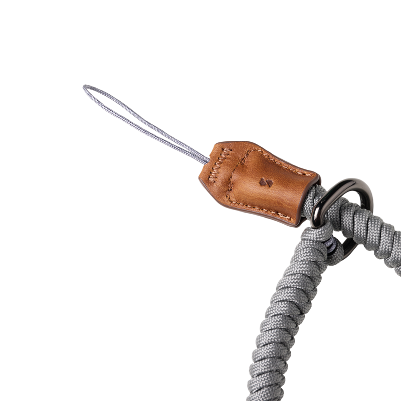 SmallRig braided wrist strap in gray, close-up of the tan leather tab