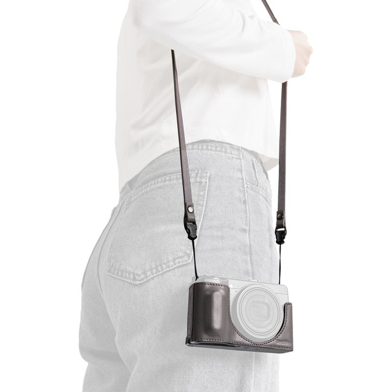 SmallRig quick release leather strap in gray, worn over the shoulder with a camera in a case
