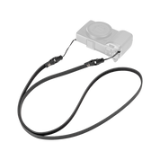 SmallRig quick release leather strap in black, laid out with a compact camera
