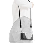 SmallRig quick release leather strap in black, worn over the shoulder with a camera in a case