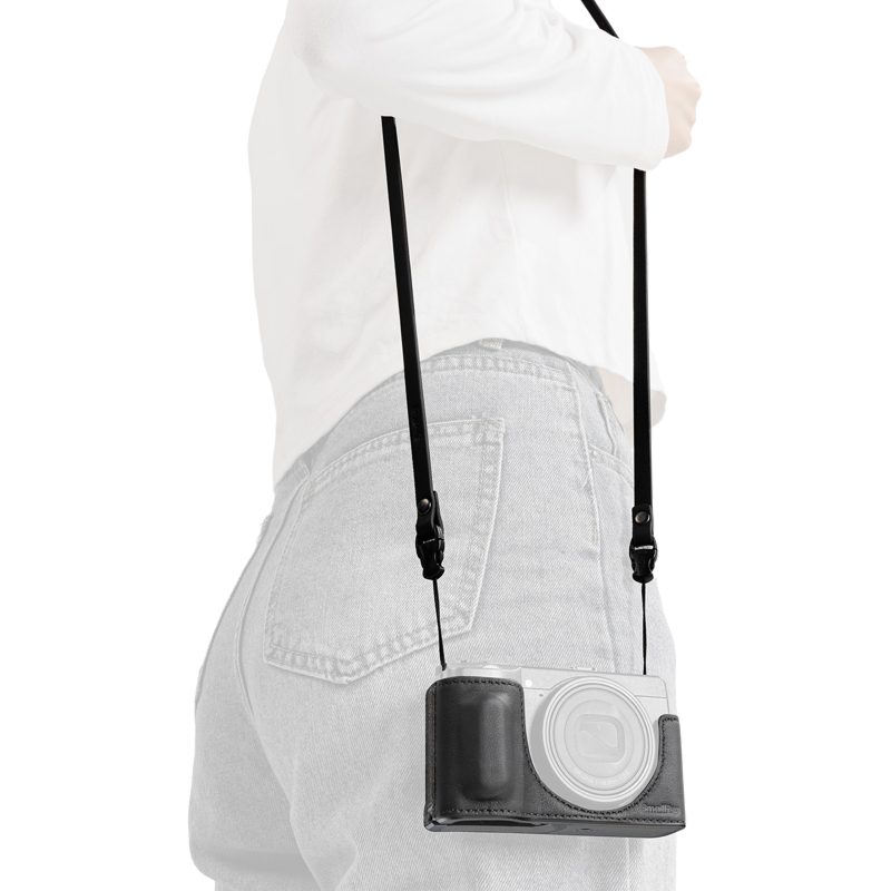 SmallRig quick release leather strap in black, worn over the shoulder with a camera in a case