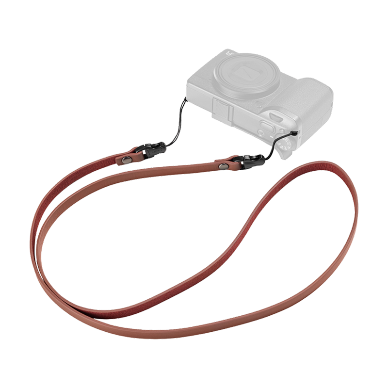 SmallRig quick release leather strap in red, laid out with a compact camera, second view